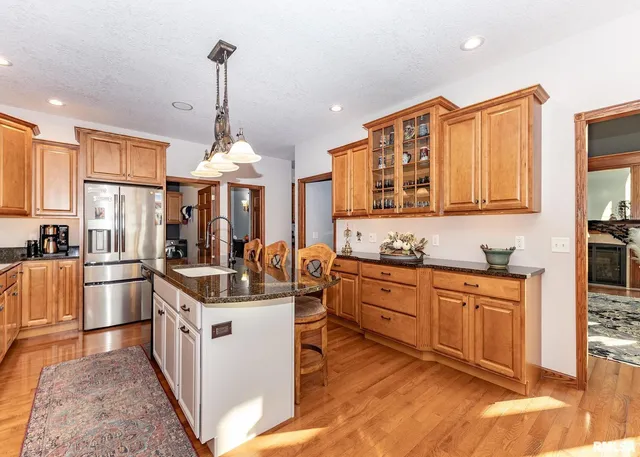 a kitchen with stove a sink and cabinets
