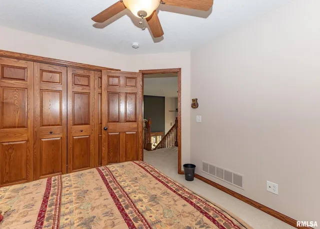 a spacious bedroom with two beds and a chandelier