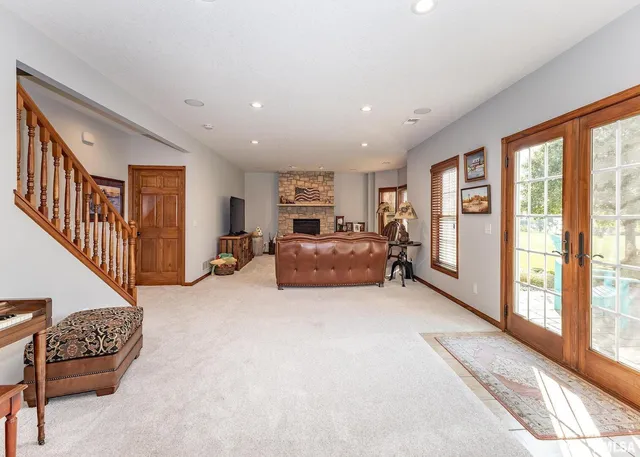 a living room with furniture large window and a flat screen tv