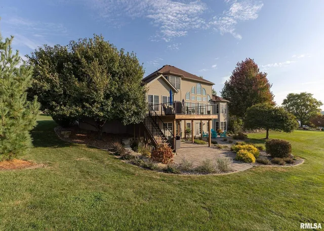 a view of a house with backyard and sitting area
