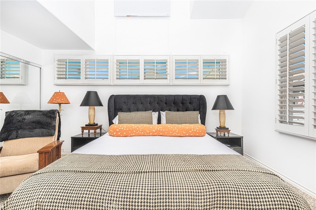 1720 West Oceanfront, Unit B Newport Beach, CA 92663 - Photo 11 of 28 a bedroom with a bed and wooden floor