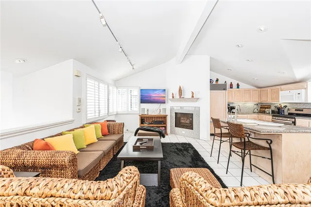 a living room with fireplace furniture and a table