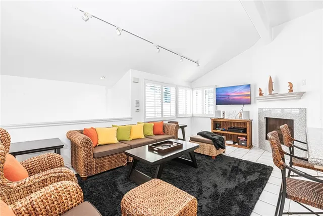a living room with furniture a rug and a fireplace