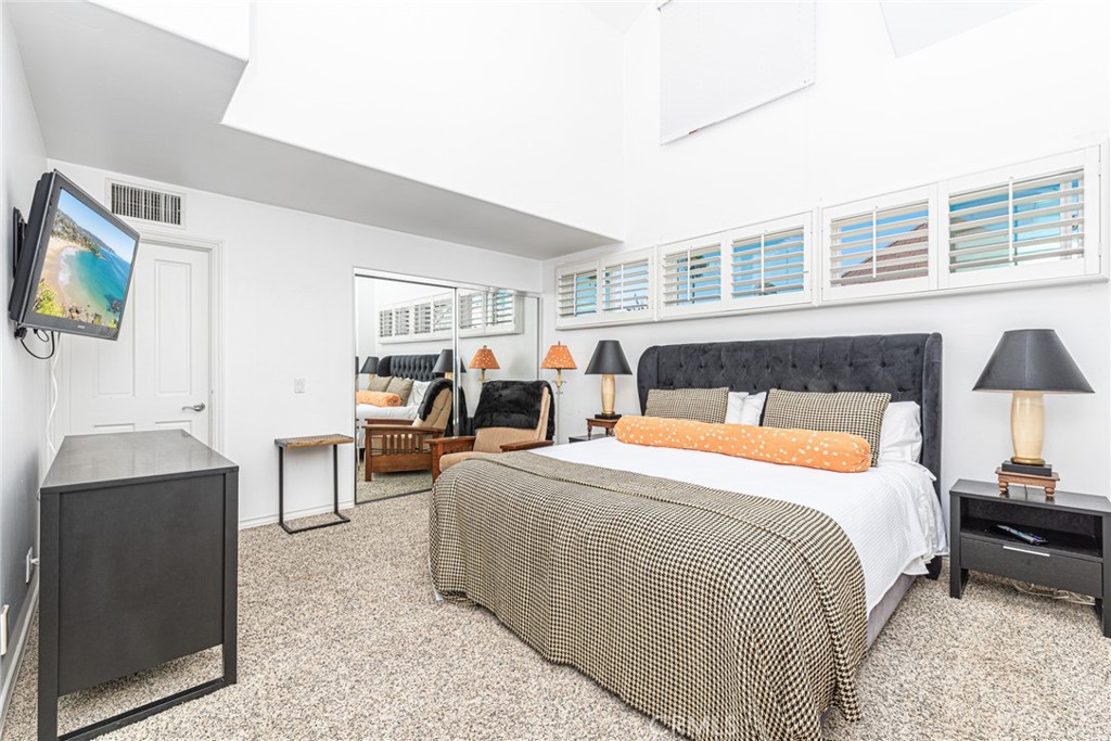 1720 West Oceanfront, Unit B Newport Beach, CA 92663 - Photo 17 of 28 a bedroom with a bed and wooden floor