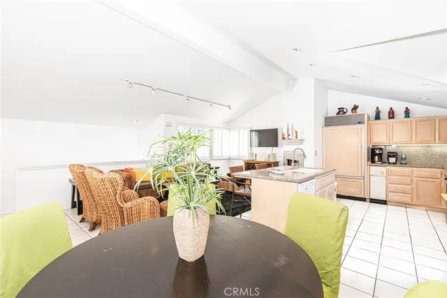 a living room with dining room and kitchen view