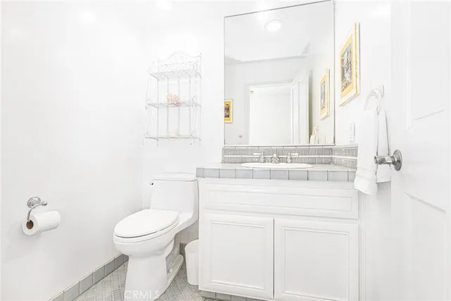 a bathroom with a sink toilet and mirror