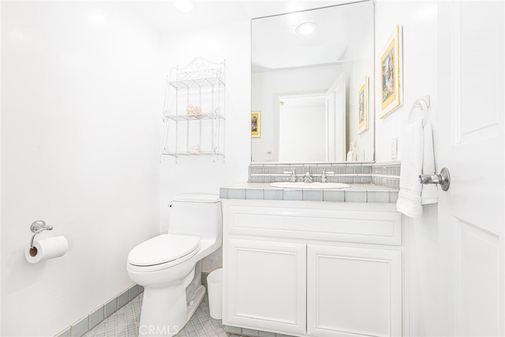 1720 West Oceanfront, Unit B Newport Beach, CA 92663 - Photo 7 of 28 a bathroom with a sink toilet and mirror