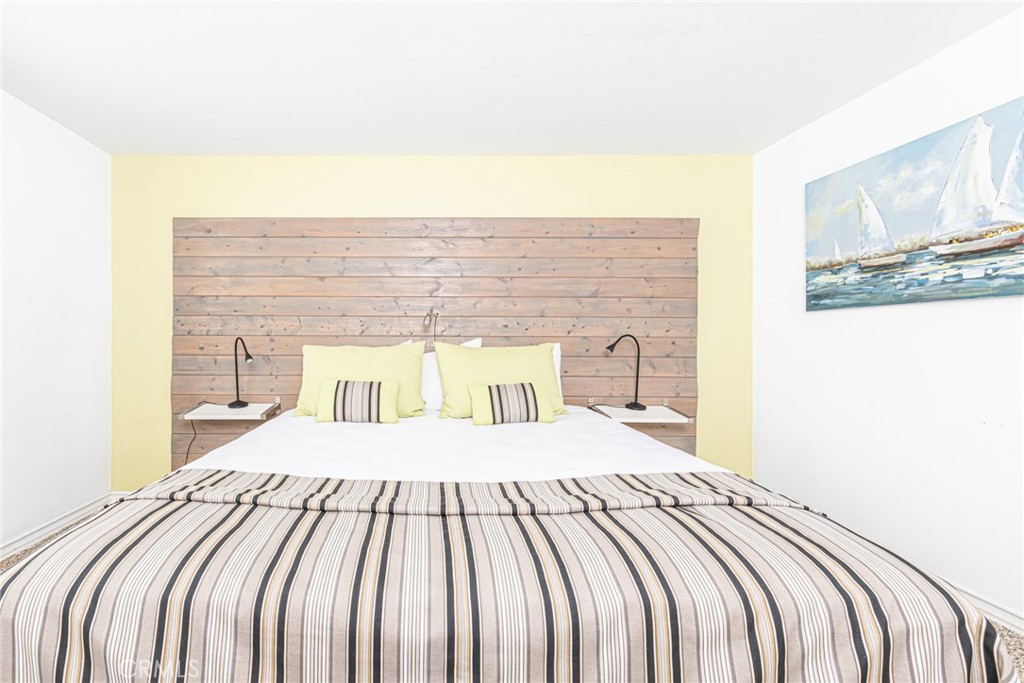1720 West Oceanfront, Unit B Newport Beach, CA 92663 - Photo 9 of 28 a bedroom with a bed and a painting on the wall