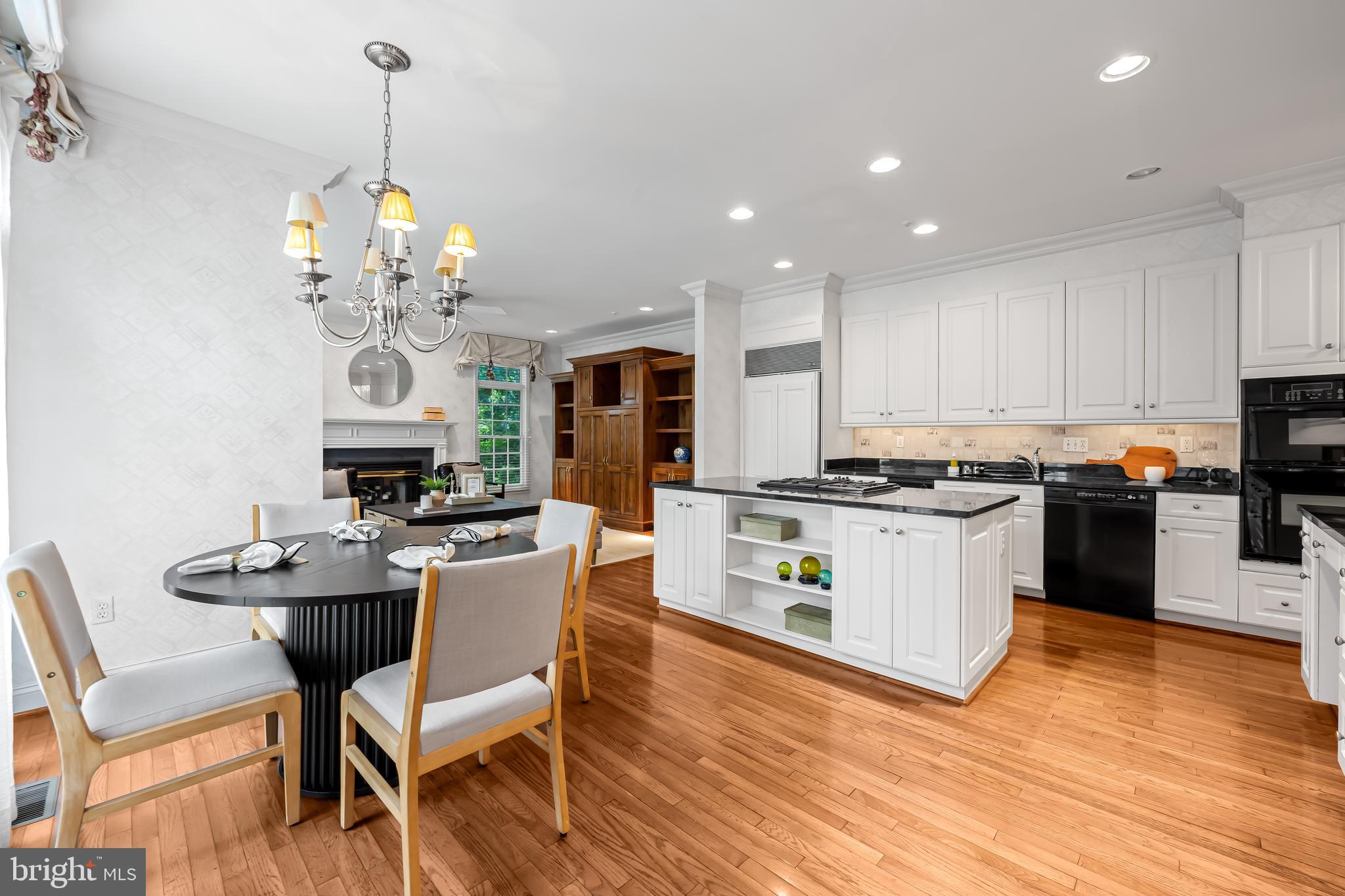 24 Roland Green, Unit 12 Baltimore, MD 21210 - Photo 11 of 53 a kitchen with stainless steel appliances kitchen island granite countertop a sink cabinets and wooden floor