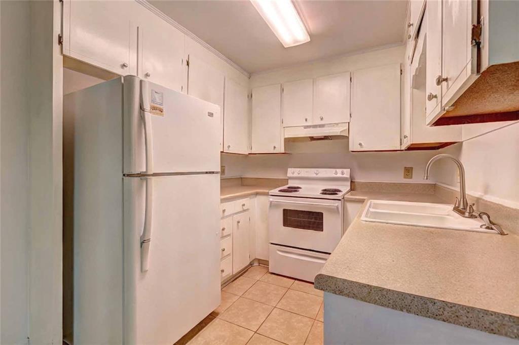 119 Windermere Circle Macon, GA 31210 - Photo 4 of 10 a kitchen with a refrigerator sink stove and cabinets