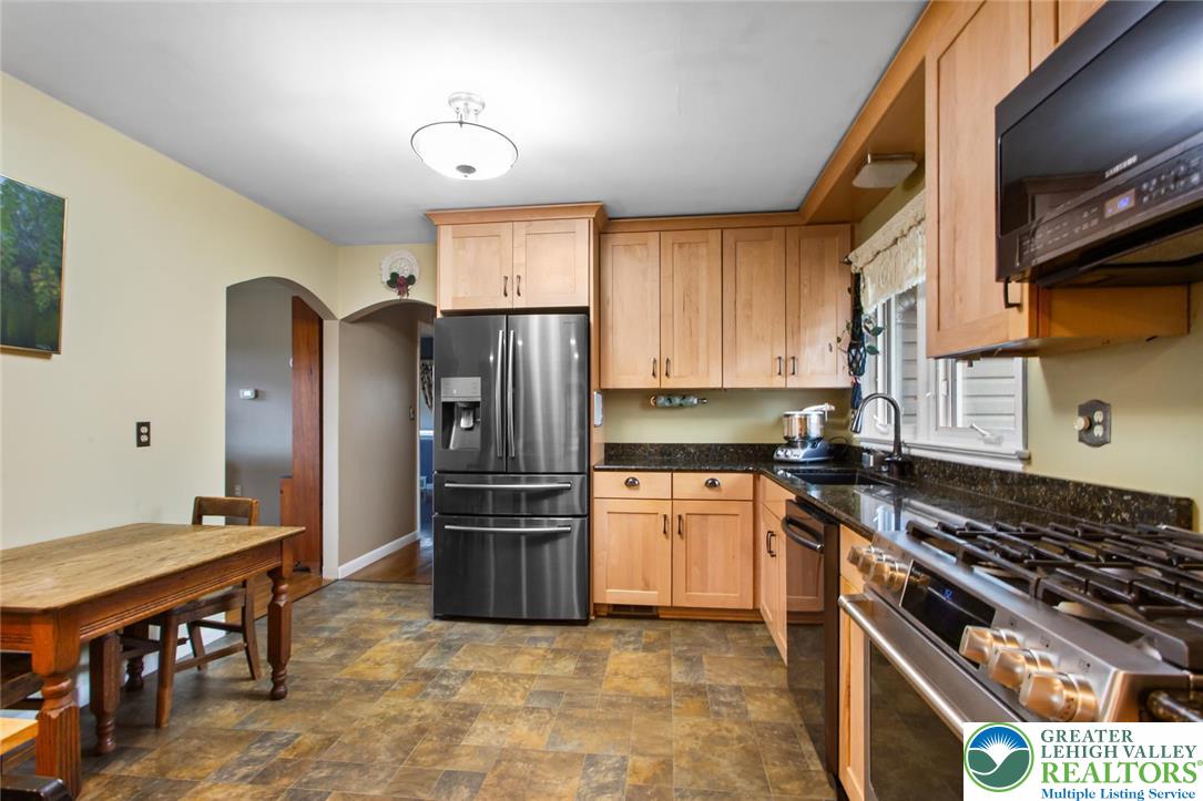 254 Old Allentown Road Wind Gap, PA 18091 - Photo 5 of 20 a kitchen with stainless steel appliances granite countertop a sink stove and refrigerator