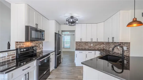 a kitchen with granite countertop a stove and a sink