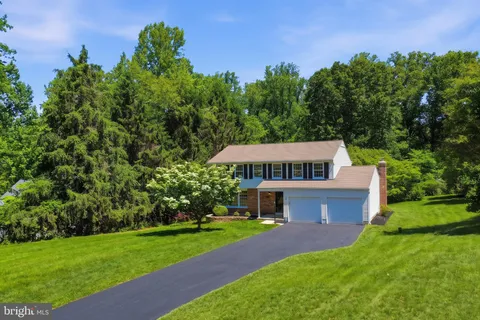 a front view of a house with a garden and yard