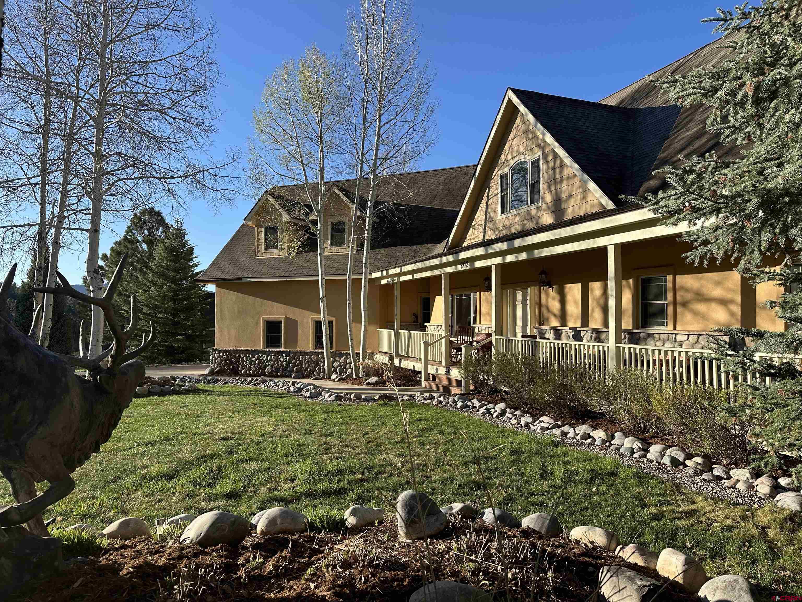 202 Rockridge Drive Durango, CO 81301 - Photo 1 of 32 a front view of a house with a yard
