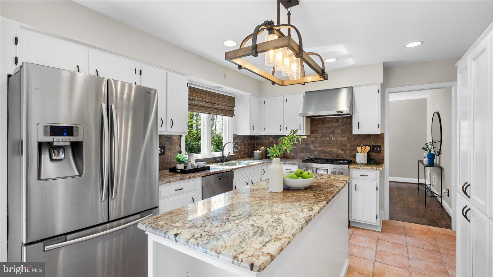 9 Nantucket Garth Phoenix, MD 21131 - Photo 16 of 52 a kitchen with stainless steel appliances granite countertop a refrigerator a stove a sink a refrigerator white cabinets and wooden cabinets