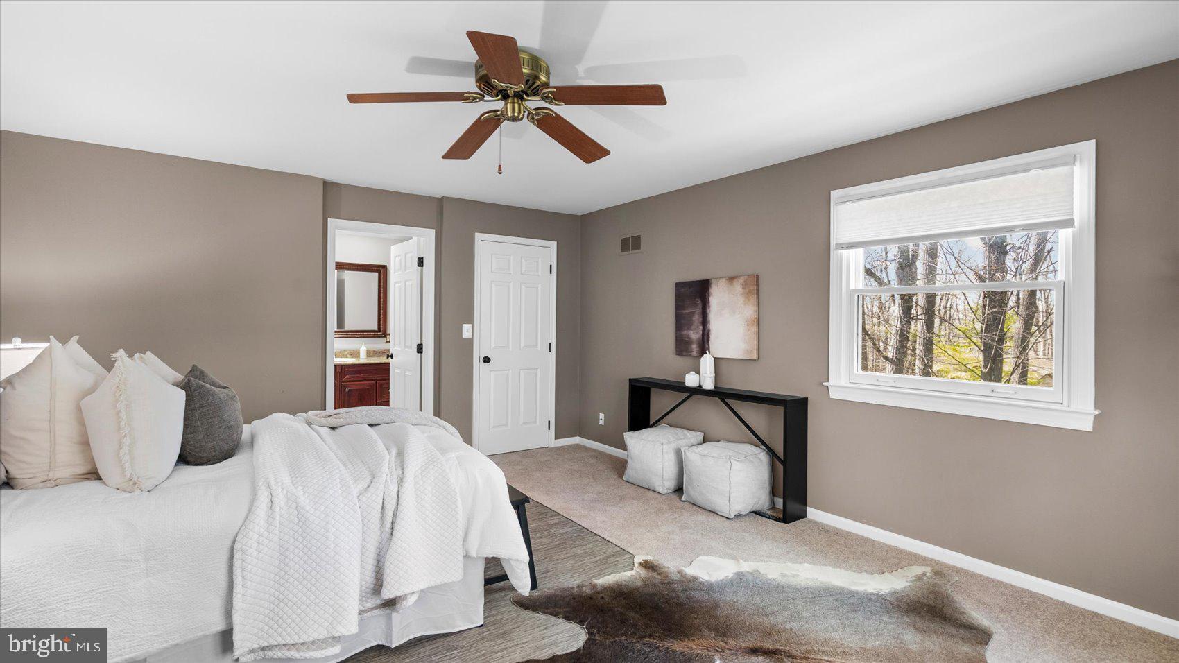 9 Nantucket Garth Phoenix, MD 21131 - Photo 27 of 52 a bedroom with a large bed and a chandelier