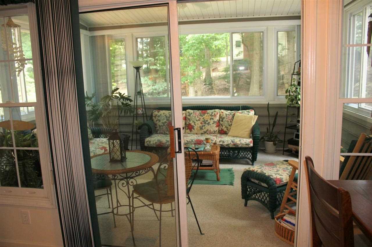 5316 Bentgrass Drive Raleigh, NC 27610 - Photo 12 of 25 The sunroom offers the possibility of quiet relaxation removed from the rest of the house by just closing the sliding glass doors.