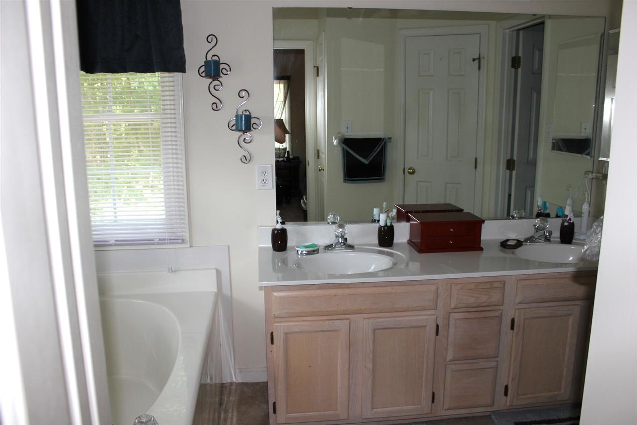 5316 Bentgrass Drive Raleigh, NC 27610 - Photo 15 of 25 Look carefully into the mirror and you'll see a reflection of the large tub and separate shower.