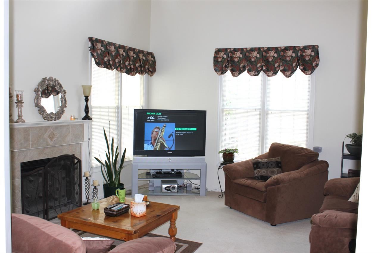 5316 Bentgrass Drive Raleigh, NC 27610 - Photo 7 of 25 Another view of this room showing the windows and giving you a hint of its high ceiling