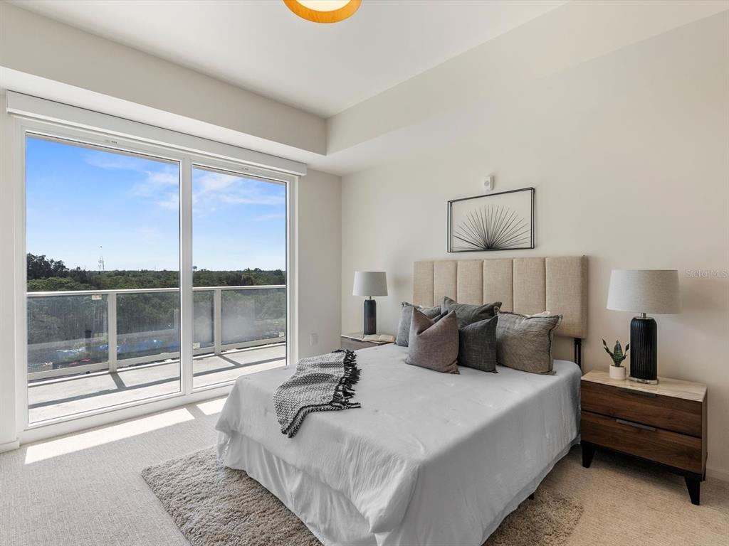 1020 Sunset Point Road, Unit 605 Clearwater, FL 33755 - Photo 13 of 35 a bedroom with a bed and a large window