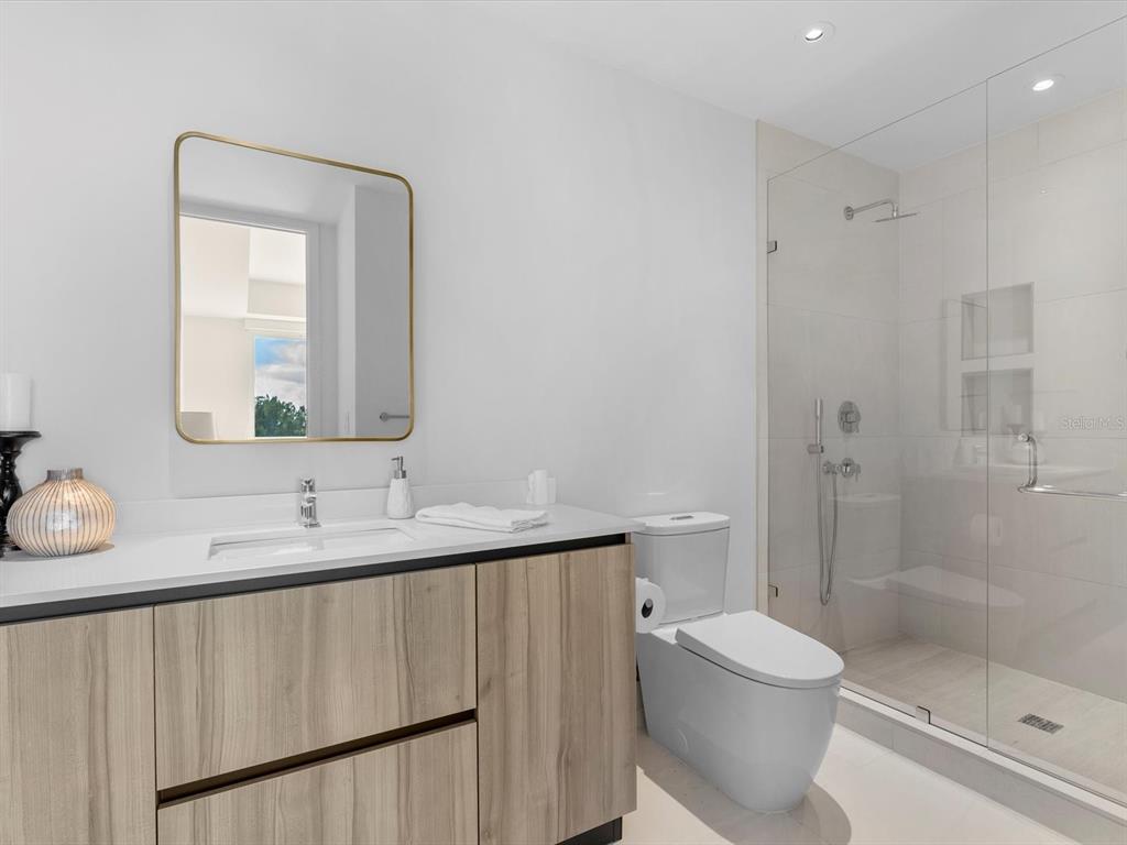 1020 Sunset Point Road, Unit 605 Clearwater, FL 33755 - Photo 14 of 35 a bathroom with a sink a toilet and shower