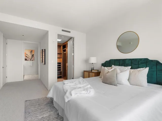 a bedroom with a bed and a large window