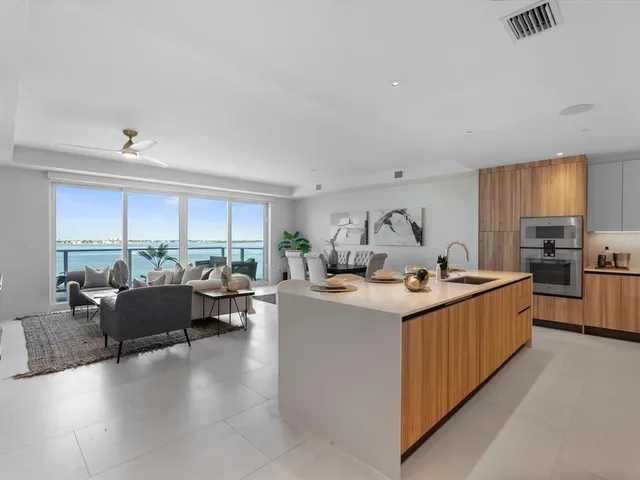 a kitchen with stainless steel appliances granite countertop a refrigerator a stove a sink and a refrigerator