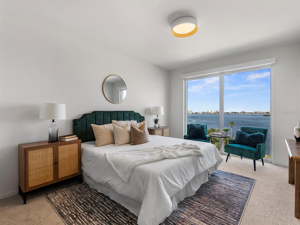1020 Sunset Point Road, Unit 605 Clearwater, FL 33755 - Photo 10 of 35 a bedroom with a bed and a large window