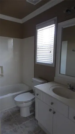 a white toilet sitting next to a bathroom sink