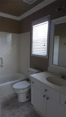 a white toilet sitting next to a bathroom sink
