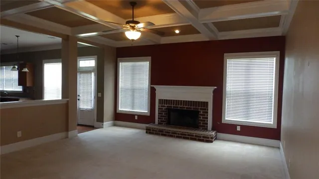 wooden floor fireplace and windows in an empty room