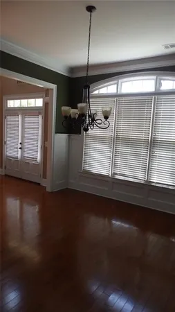 a view of a room with wooden floor and windows