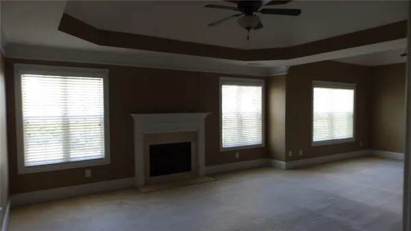 a view of an empty room with a fireplace and a window