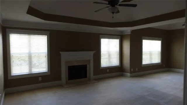a view of an empty room with a fireplace and a window
