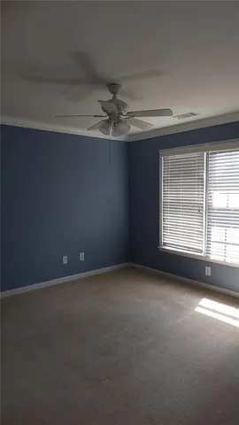 a view of a field of grass and trees