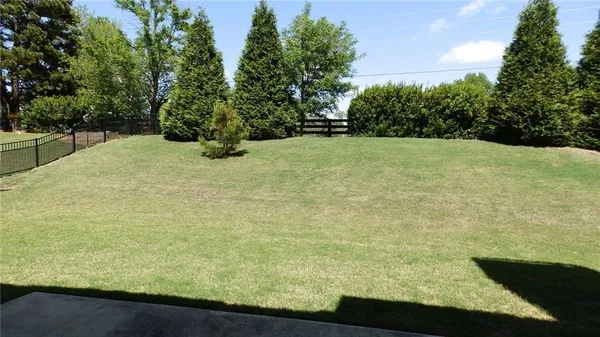 a view of a house with a yard patio and furniture