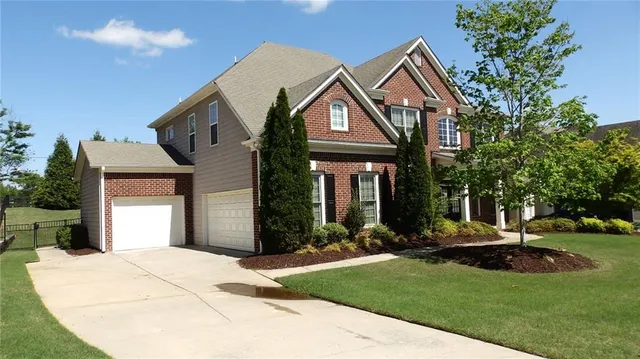 a front view of a house with garden