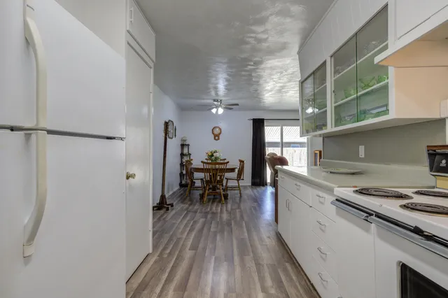 a kitchen with sink cabinets and wooden floor