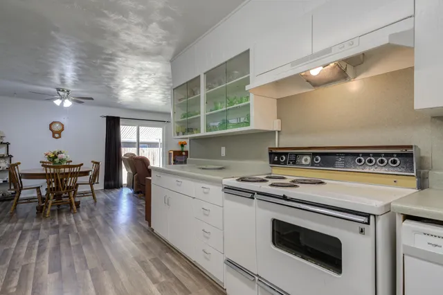 a view of a kitchen with stove and wooden floor