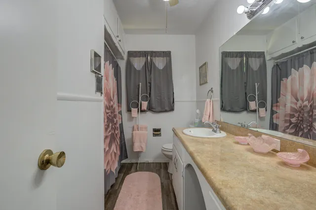 a bathroom with a sink vanity and mirror