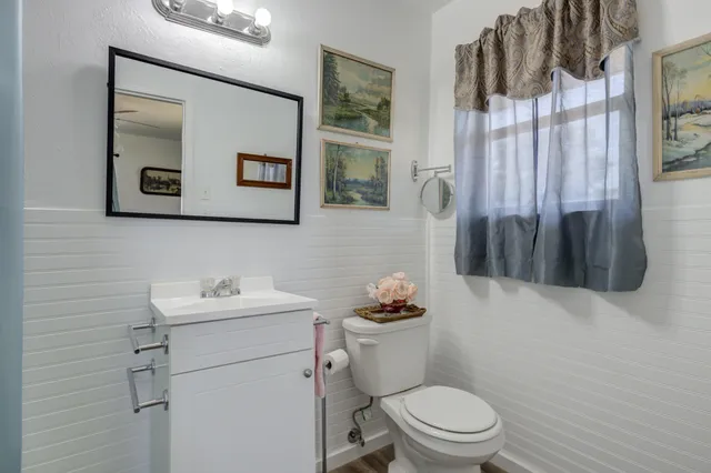 a bathroom with a toilet sink and mirror