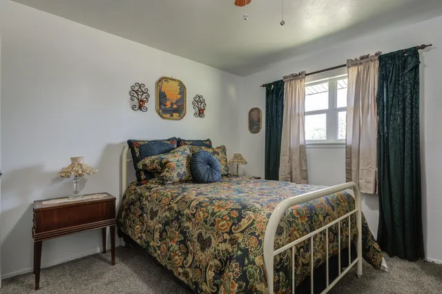 a bedroom with a bed and a lamp on table