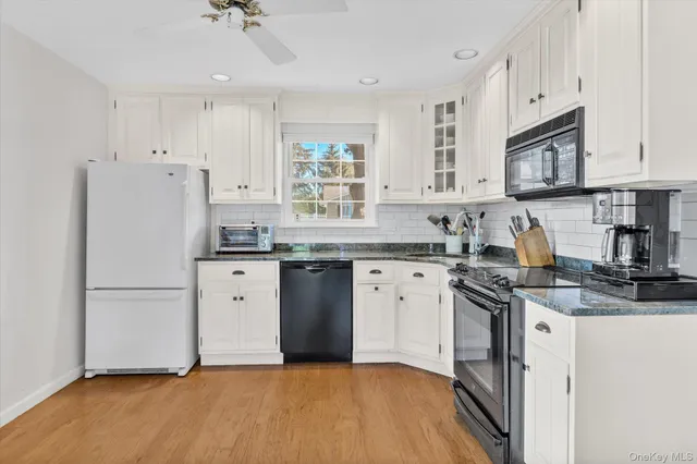 a kitchen with stainless steel appliances granite countertop a refrigerator sink and stove