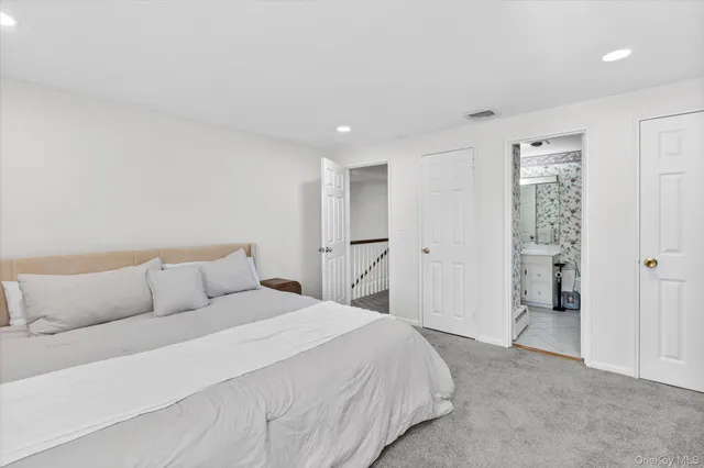 a bedroom with a bed and cabinets
