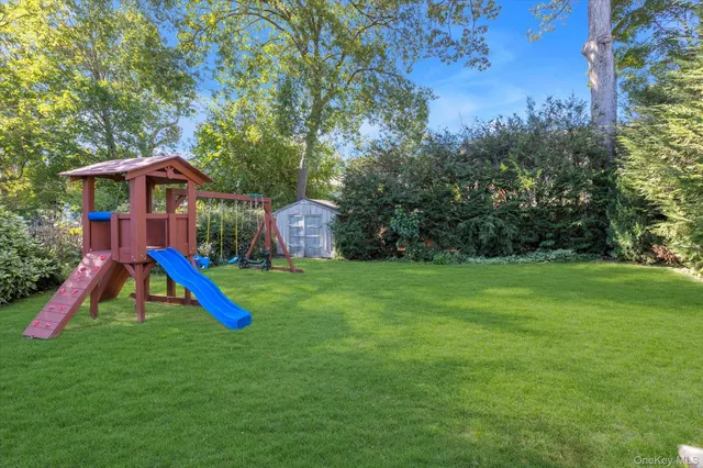 a view of a house with a backyard and swimming pool