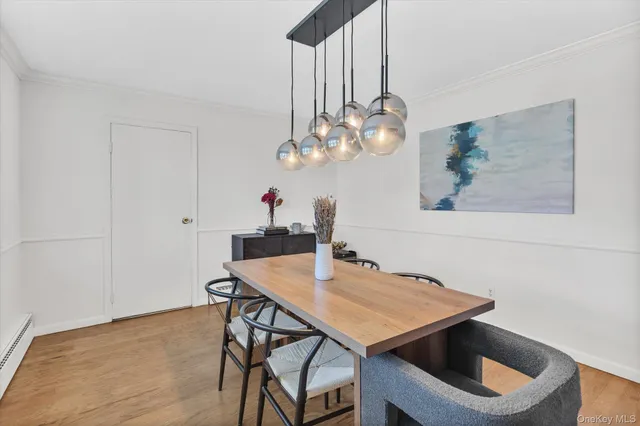 a view of a dining room with furniture and chandelier