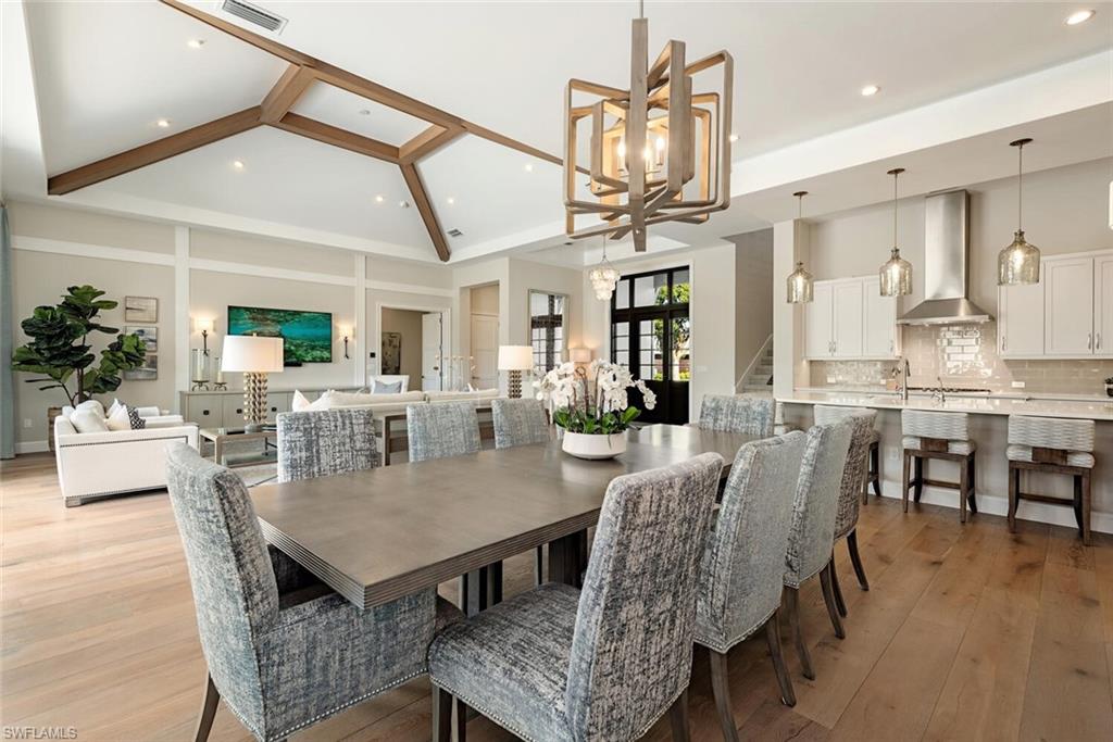 16715 Enclave Circle Naples, FL 34110 - Photo 16 of 33 a view of a dining room with furniture and wooden floor