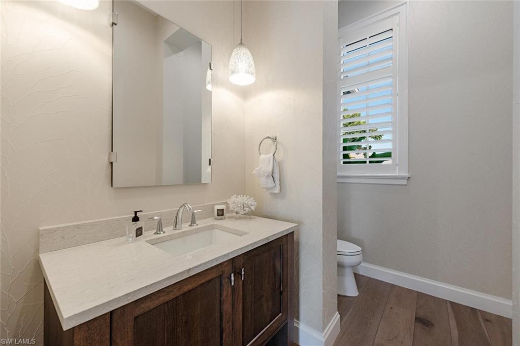 16715 Enclave Circle Naples, FL 34110 - Photo 17 of 33 a bathroom with a sink a toilet and a mirror