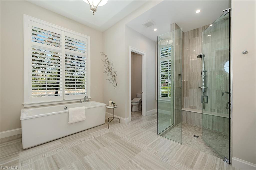 16715 Enclave Circle Naples, FL 34110 - Photo 20 of 33 a bathroom with a bathtub shower sink and toilet