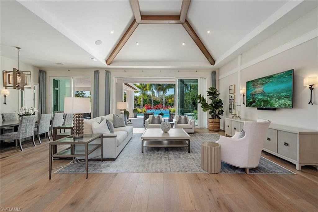 16715 Enclave Circle Naples, FL 34110 - Photo 2 of 33 a living room with furniture and a flat screen tv